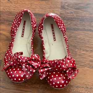 Prada red polka dot shoes have been worn .